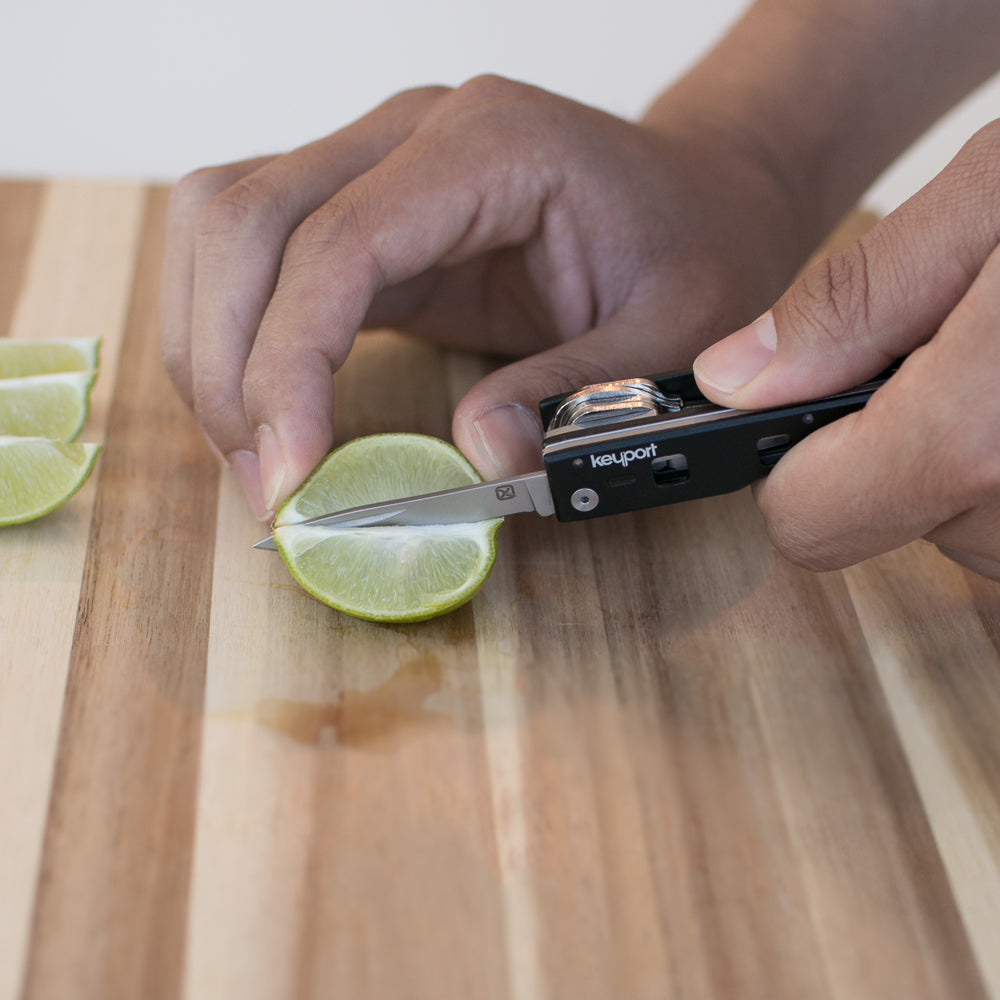 Black Keyport Pocketknife Module cutting a lime